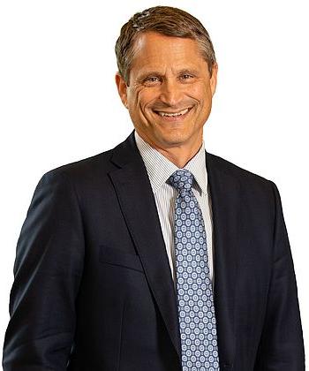 Headshot photo of Alex Bryan smiling against a white background